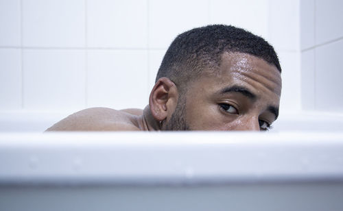 Portrait of young man in bathroom