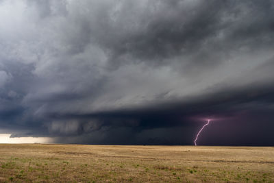 Supercell thunderstorm with lightning bolt and dramatic clouds near springfield, colorado.