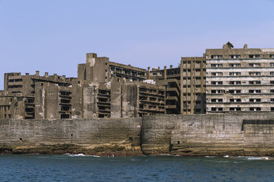 Buildings in city against clear sky