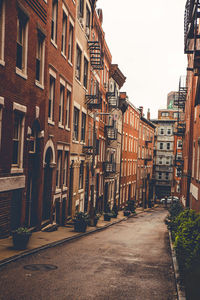 Street amidst buildings against sky