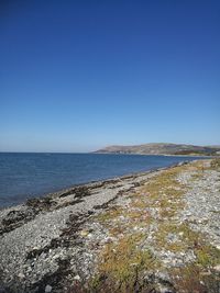 Scenic view of sea against clear blue sky