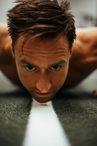 Shirtless man exercising in gym