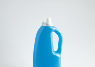 Blue plastic bottle with a grey cap isolated for liquid detergent laundry or cleaning agent.

