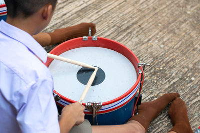 High angle view of man playing guitar on street