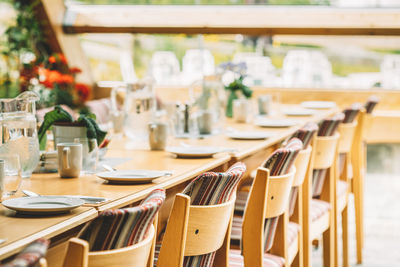 Empty chairs and tables in restaurant