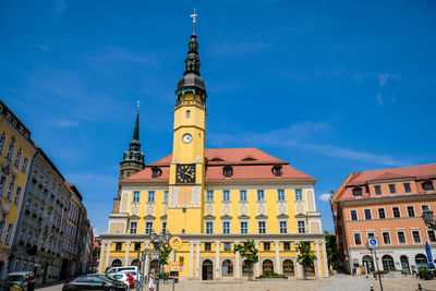 Low angle view of buildings against blue sky