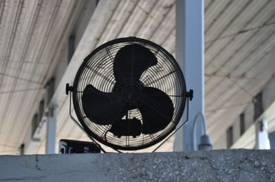 Low angle view of electric fan on wall