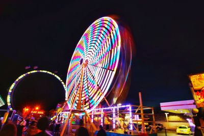 Low angle view of illuminated ferris wheel