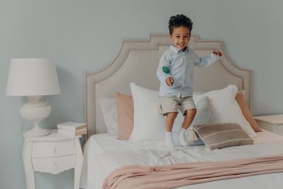 Full length of boy wearing hat at home