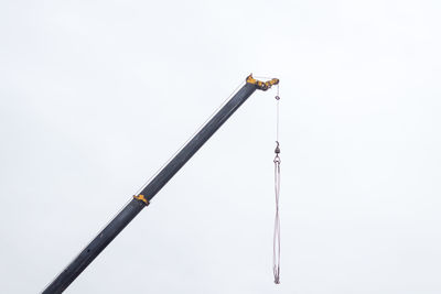 Low angle view of crane against white background