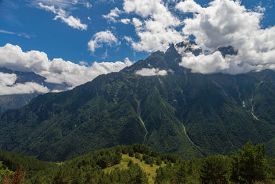 View of huge mountains with waterfalls and beautiful clouds in north ossetia
