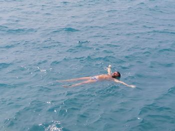 High angle view of man swimming in sea