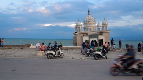 People riding bicycles on the beach
