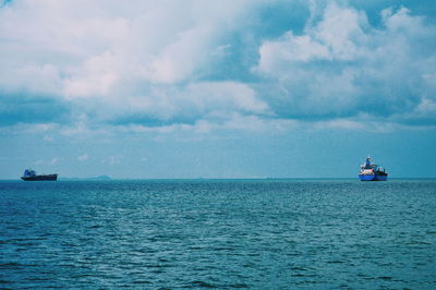 Sailboat sailing on sea against sky