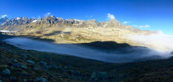 Scenic view of mountains against cloudy sky