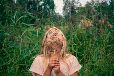 Portrait of girl holding plant