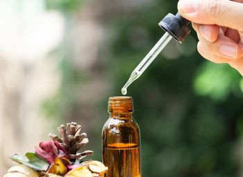 Close-up of hand holding glass bottle