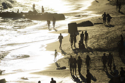 Silhouette people walking on sunset