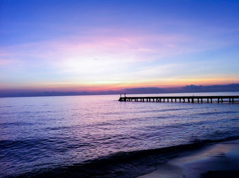 Scenic view of sea against romantic sky at sunset