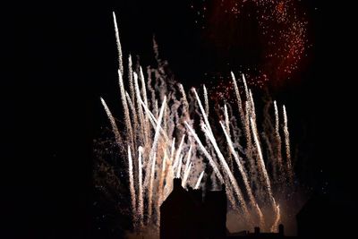 Close-up of illuminated lamp over black background