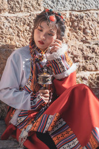 Portrait of young woman sitting on field