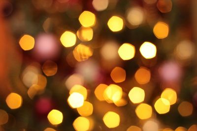 Defocused image of illuminated christmas lights at night