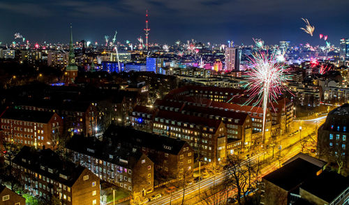 High angle view of illuminated buildings in city at night