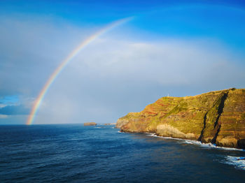 Coastal view and atlantic ocean with rainbow, ponta da ferraria, sao miguel island, azores, portugal