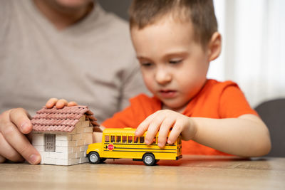 Portrait of boy playing with toy blocks at home