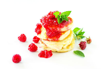 Close-up of strawberries in plate against white background