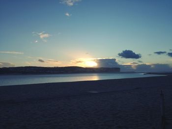 Scenic view of beach against sky during sunset