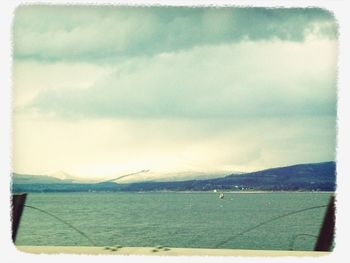 Scenic view of mountains against cloudy sky