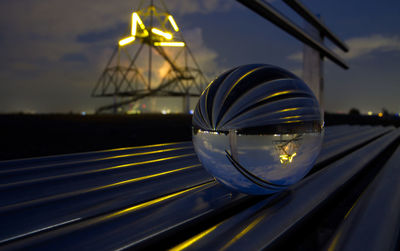 Close-up of illuminated lighting equipment on railing