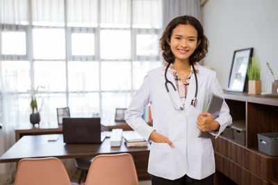 Portrait of female doctor standing in office