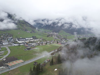 High angle view of road amidst buildings against sky