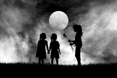 Teenager giving flowers to girls against full moon