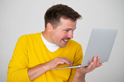 Man using mobile phone while sitting on table