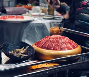 Close-up of man preparing food in plate