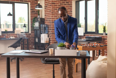 Portrait of businessman using laptop at table