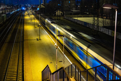 High angle view of train at railroad station during night