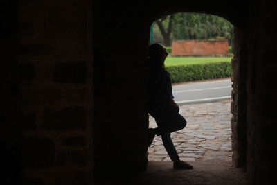 Full length of woman standing in archway