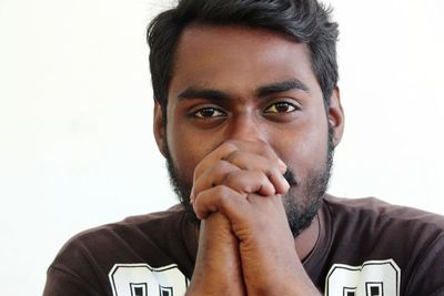 Close-up portrait of young man against white background