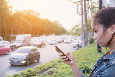 Midsection of man using mobile phone