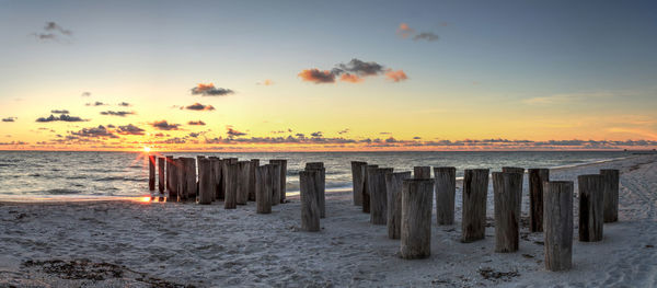 Dilapidated ruins of a pier on port royal beach at sunset in naples, florida