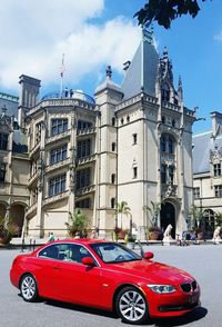 Red car against sky in city