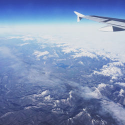 Cropped image of airplane flying over landscape