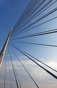 Low angle view of suspension bridge against sky