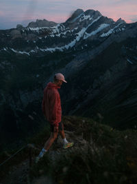 Rear view of man standing on mountain