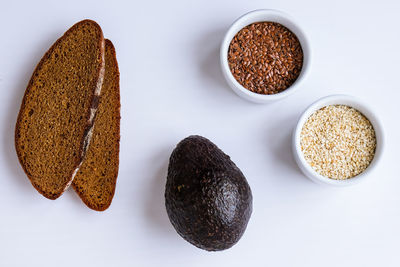 Ingredients for healthy avocado toast. ripe hass avocado, wholegrain bread, sesame flax 