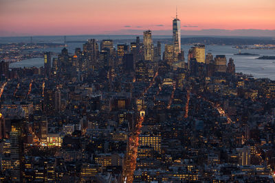 Aerial view of city lit up at sunset